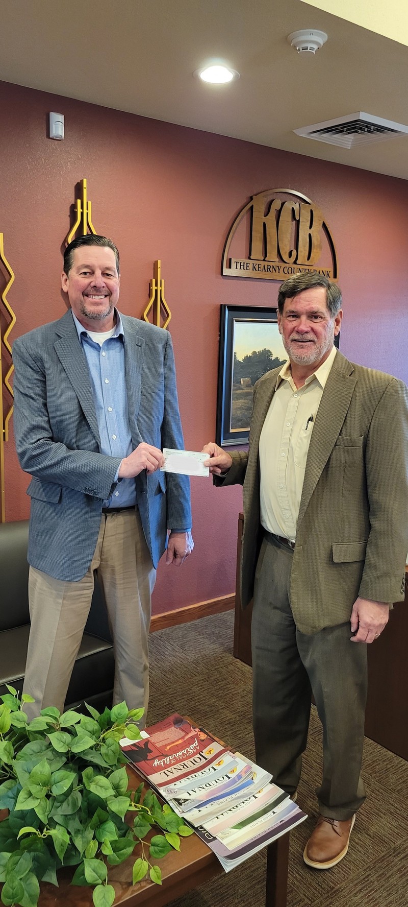 Kearny County Bank CEO, John Young (Left), presenting the check to Bob Beymer, CFO, and Chair of Kearny County Community Foundation in Lakin, KS.
