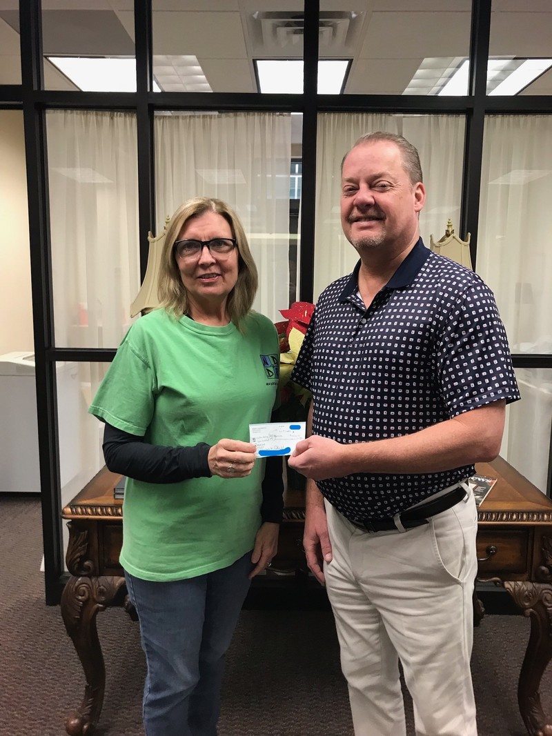 Donna Clanton of New Destiny Dog Rescue receives the check from Mike Rittenberry of Peoples Bank of Middle Tennessee in Shelbyville, TN.
