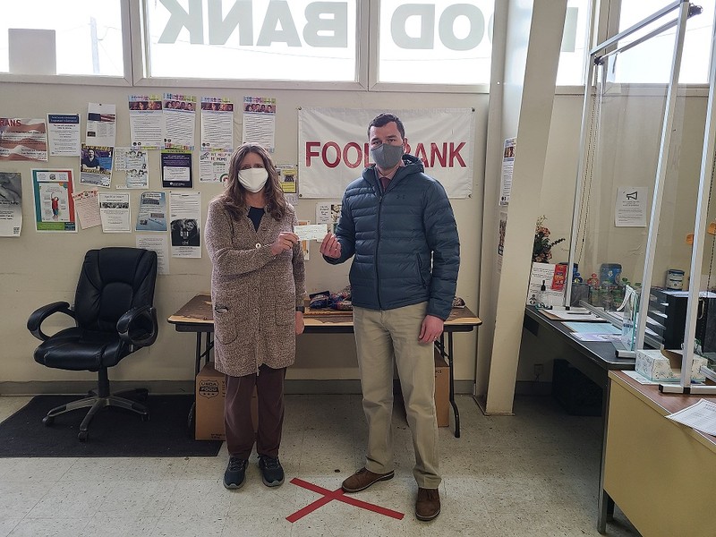 Kathy Siler, Director of the Food Bank of Sweetwater County, receives the donation check from Jason McFadden, CFO of RSNB Bank, in Rock Springs, WY.