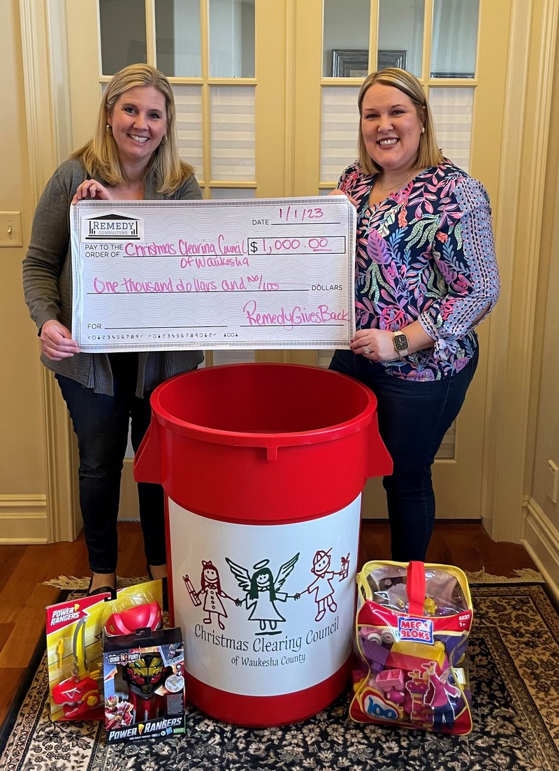 Karen Lowerr of Remedy Consulting presenting check to Christmas Clearing Council of Waukesha County representative Nancy McCaskey in Waukesha, Wisconsin.