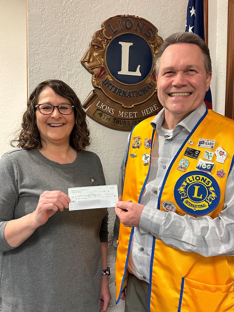 Jean Tworek, Independence State Bank's Elk Mound Vice President, presenting check to President Scott Johnson in Elk Mound, Wisconsin.