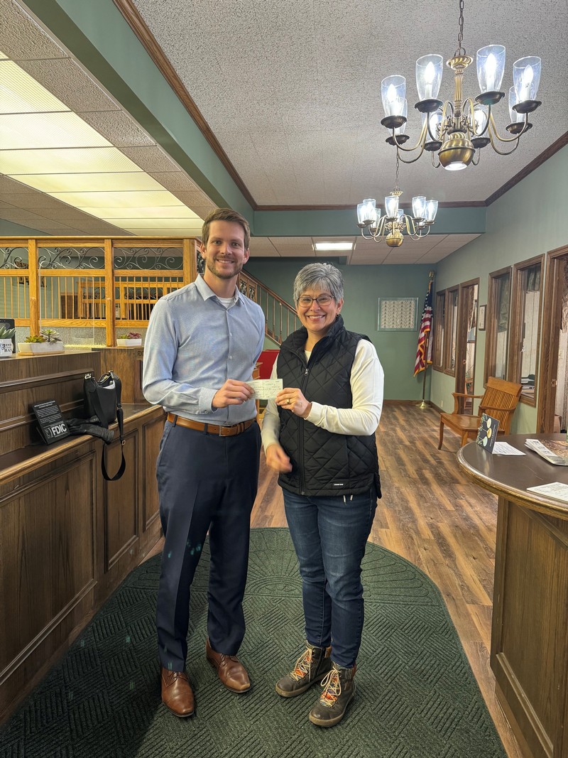 Scott Freiburger, President & CEO of Benton State Bank, presenting the check to Michelle Savatski with Village of Benton and CFSW to fund the new library, museum, and community center in January 2024.