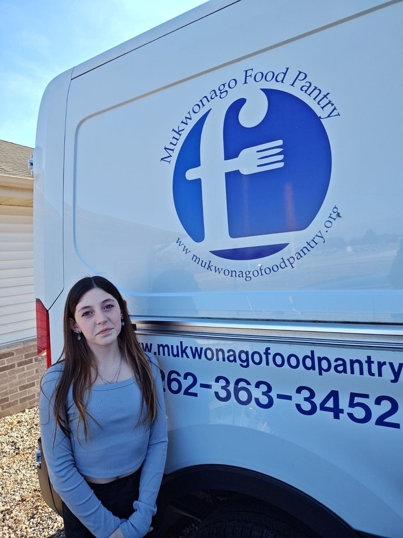 Hink Family of Remedy Consulting presenting the check to Mukwonago Food Pantry located in Mukwonago, Wisconsin in January 2024.