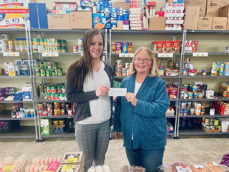 Bethany Arnold, Branch Manager of River Bank, presents check to Lori Ascher, President of Bread Basket Ecumenical Food Pantry in Sparta, WI in January 2024.