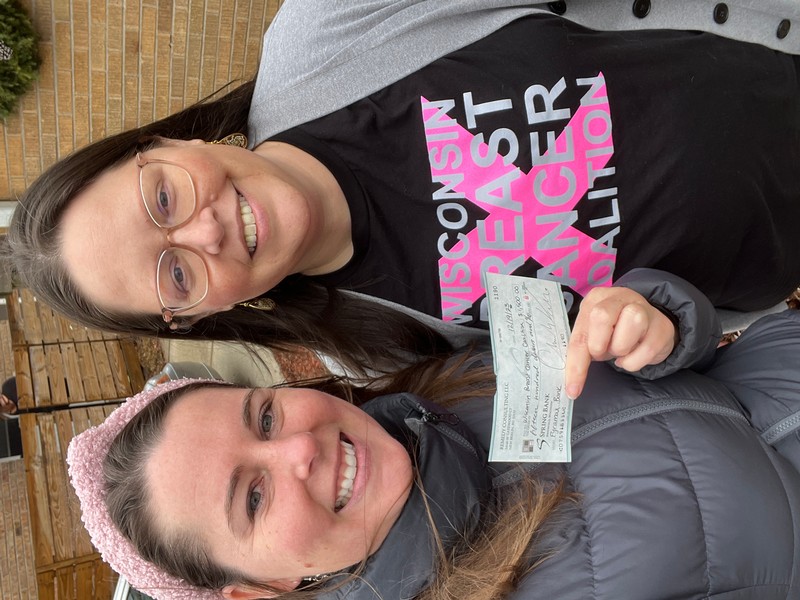 Vanessa Pfeiffer of PyraMax Bank (WI) presents the check to Lindsey, volunteer for Wisconsin Breast Cancer Coalition in Milwaukee, WI in December 2023.