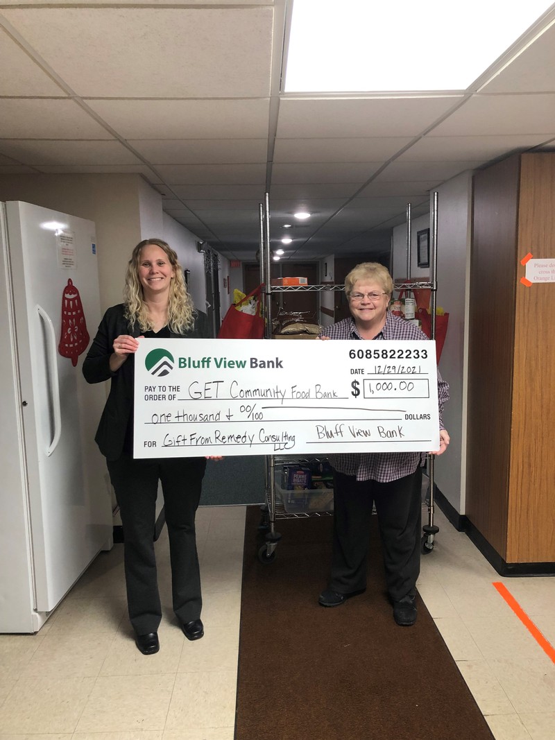 Lindsay Spitzer, COO of Bluff View Bank (WI), presenting check to Linda Hogden of GET Community Food Bank in Galesville, WI.