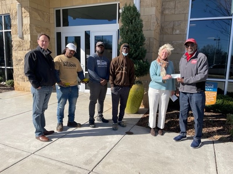 Piedmont Federal Savings Bank (NC) employees presenting the check to The Do School representatives in 2021 in Winston Salem, NC.