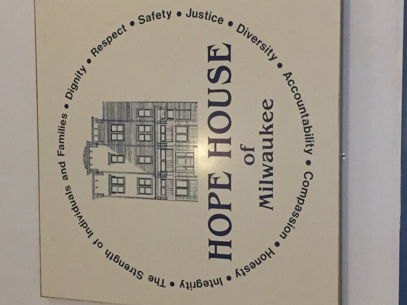 Brian Hink of Remedy Consulting presenting check to Hope House of Milwaukee representative in Milwaukee, WI.